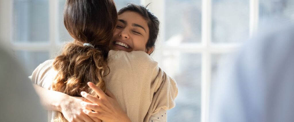 two female friends sharing a hug