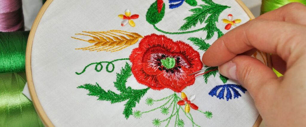 Hand embroidering red flower using embroidery hoop